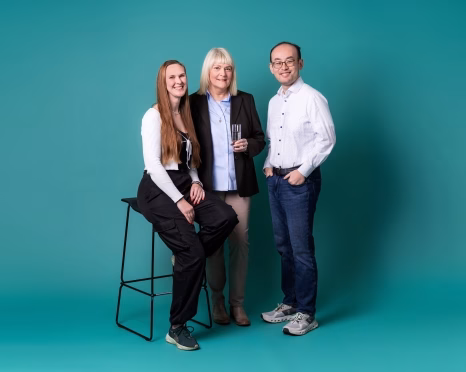 Three in suits on teal backdrop - Getec Hamburg - GETEC