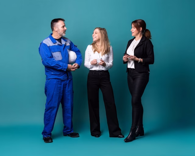 Three people holding soccer ball - Basel - GETEC