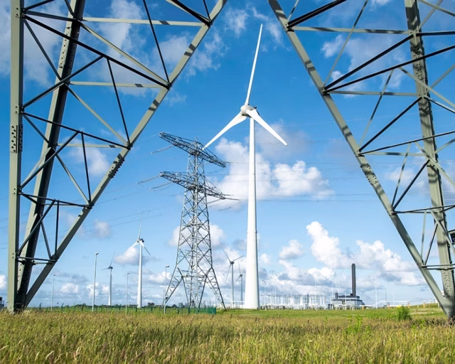 Electric power lines under blue sky - Emmen Renewable Energies - GETEC