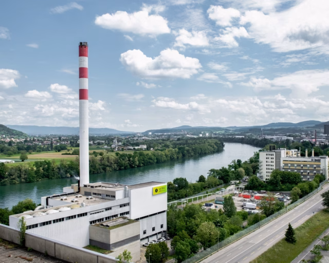 Industrial plant by river under blue sky - GETEC